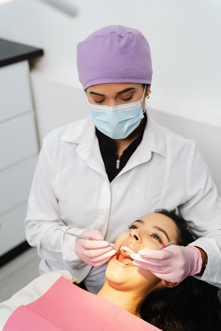 Dentist providing gentle, attentive dental exam at Devoted Dental Group