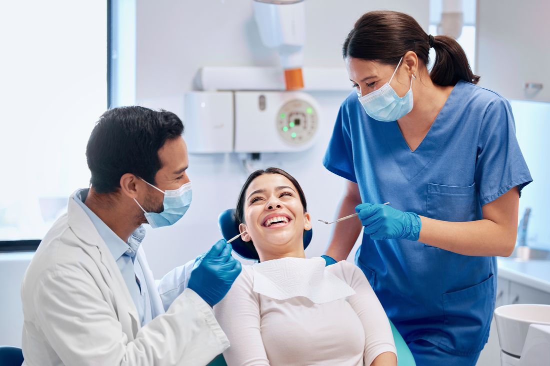 Laughing patient enjoying a comfortable visit with the Devoted Dental Group team