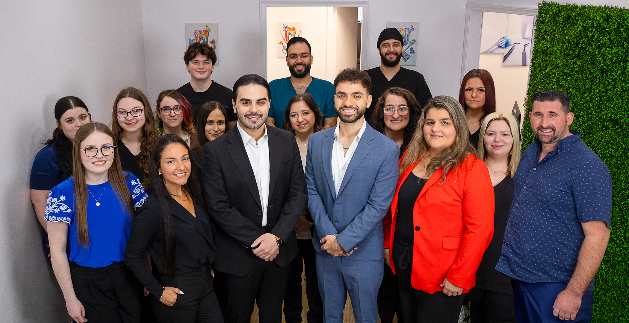 Professional team photo of the experienced dentists and staff at Devoted Dental offering family dentistry, cosmetic dentistry, dental implants, and emergency dental care in Wyandotte, MI.